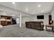 Spacious living room boasts neutral paint, recessed lighting, and comfortable seating for relaxing and entertaining at 5386 W 1100 N, Fountaintown, IN 46130