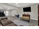 Open-concept living room with a large TV, modern decor, and plenty of space for entertaining or relaxing at 5386 W 1100 N, Fountaintown, IN 46130