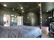 Spacious main bedroom featuring dark walls and ceilings with a four poster bed and ceiling fan at 5386 W 1100 N, Fountaintown, IN 46130