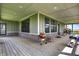 Spacious outdoor porch with a beautiful hardwood floor and outdoor cooking and relaxation space at 5386 W 1100 N, Fountaintown, IN 46130