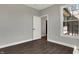 Minimalist room features light grey walls, dark floors, and view to the backyard through a window at 5386 W 1100 N, Fountaintown, IN 46130