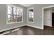 Light filled room shows neutral walls, dark floors, and bright windows with views to the backyard at 5386 W 1100 N, Fountaintown, IN 46130