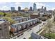 Aerial view of townhouses in an urban neighborhood with downtown skyline in the background at 548 Lockerbie N Cir, Indianapolis, IN 46202