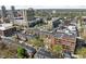 An elevated view shows townhouses nestled in a vibrant urban landscape with city buildings and lush green spaces surrounding the area at 548 Lockerbie N Cir, Indianapolis, IN 46202