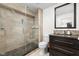 Elegant bathroom with tiled walk-in shower, dark wood vanity, granite countertop, and decorative mosaic backsplash at 548 Lockerbie N Cir, Indianapolis, IN 46202