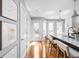 Bright kitchen featuring a large island with seating, modern appliances, and hardwood floors with access to outdoor deck at 548 Lockerbie N Cir, Indianapolis, IN 46202