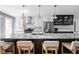 Large kitchen island with granite countertops, seating, and pendant lighting, perfect for meal preparation and casual dining at 548 Lockerbie N Cir, Indianapolis, IN 46202