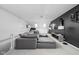 Bright living room featuring a grey sectional sofa, large television, and a ceiling fan at 548 Lockerbie N Cir, Indianapolis, IN 46202