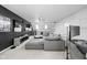 Open living room with large grey sectional sofa, mounted television, and a modern workstation at 548 Lockerbie N Cir, Indianapolis, IN 46202