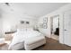 Well-lit main bedroom with neutral decor, comfortable bedding, and access to an en-suite bathroom at 548 Lockerbie N Cir, Indianapolis, IN 46202