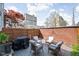 Cozy backyard patio featuring comfortable outdoor seating, a grill, and a privacy fence at 548 Lockerbie N Cir, Indianapolis, IN 46202