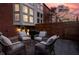 Cozy patio area with comfortable seating, a grill, and a privacy fence, perfect for outdoor relaxation and entertaining at 548 Lockerbie N Cir, Indianapolis, IN 46202
