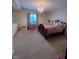 Cozy bedroom with rainbow bedding, chandelier, and dresser, creating a comfortable and inviting space at 5601 Harness Dr, Greenwood, IN 46143