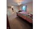 Bright bedroom with rainbow bedding, chandelier, and walk-in closet with plenty of storage space at 5601 Harness Dr, Greenwood, IN 46143