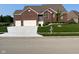 Charming brick home with a well-manicured lawn and an inviting entrance, plus a two-car garage at 5601 Harness Dr, Greenwood, IN 46143