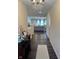 Inviting hallway with hardwood floors leads to a living area with a chandelier at 5601 Harness Dr, Greenwood, IN 46143