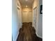 Hallway featuring multiple doors and hardwood floors at 5601 Harness Dr, Greenwood, IN 46143