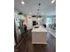 Modern kitchen with stainless steel appliances, white cabinets, and a large island at 5601 Harness Dr, Greenwood, IN 46143