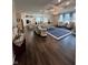 Expansive open floor plan with modern furnishings, flowing from the kitchen to the living area at 5601 Harness Dr, Greenwood, IN 46143