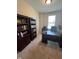 Spacious office featuring a large desk, bookshelves and natural light from the window at 5601 Harness Dr, Greenwood, IN 46143