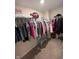 Walk-in closet featuring ample hanging space for organized storage and a charming blue bench at 5601 Harness Dr, Greenwood, IN 46143
