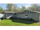 Rear view of house featuring gray siding, green lawn, and window at 5831 Aho Dr, Avon, IN 46123