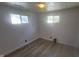 Cozy bedroom featuring hardwood floors, a ceiling fan and dual windows at 5831 Aho Dr, Avon, IN 46123