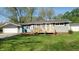 Charming single-story home with a wooden front porch and manicured lawn at 5831 Aho Dr, Avon, IN 46123