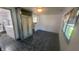View of the living room with marble print flooring and window, also showing laundry area and small kitchen at 5831 Aho Dr, Avon, IN 46123