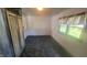 View of the living room with decorative cabinet, window, and marble print flooring at 5831 Aho Dr, Avon, IN 46123
