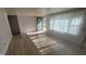 Bright living room with hardwood floors, large window, and modern front door at 5831 Aho Dr, Avon, IN 46123