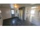 View of the living room with decorative cabinet and marble print flooring, opens to kitchen and exterior door at 5831 Aho Dr, Avon, IN 46123