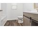 Cozy bathroom featuring dark flooring, a vanity with light wood accents, and a toilet at 600 S Vine St, Muncie, IN 47302