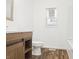 Bathroom featuring a modern vanity with wood cabinets and an updated toilet at 600 S Vine St, Muncie, IN 47302