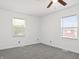 Neutral bedroom featuring gray carpet, white walls, and windows for natural light at 600 S Vine St, Muncie, IN 47302