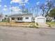 Home featuring a detached garage and a well-maintained yard at 600 S Vine St, Muncie, IN 47302