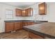 Spacious kitchen with wood cabinets, black countertops, and a corner sink at 600 S Vine St, Muncie, IN 47302