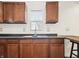 Updated kitchen featuring wood cabinets and a stainless steel faucet under a window at 600 S Vine St, Muncie, IN 47302