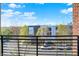A balcony view showcases the neighborhood with visible roads and a sunny sky above at 622 E 10Th St # 312, Indianapolis, IN 46202