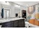 Bathroom featuring double sinks, granite countertops, and modern vanity for a luxurious feel at 622 E 10Th St # 312, Indianapolis, IN 46202
