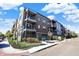 Modern three-story building with brick and siding, balconies, landscaping, and a private garage at 622 E 10Th St # 312, Indianapolis, IN 46202