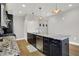 Modern kitchen with stainless steel appliances, granite countertops and dark cabinetry at 622 E 10Th St # 312, Indianapolis, IN 46202
