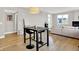 Open-concept living space featuring hardwood floors and a stylish bar height table set at 622 E 10Th St # 312, Indianapolis, IN 46202