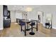 Open living space featuring hardwood floors, modern light fixtures and dining table at 622 E 10Th St # 312, Indianapolis, IN 46202