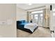 Cozy main bedroom featuring a balcony, comfortable bedding, and soft carpeting at 622 E 10Th St # 312, Indianapolis, IN 46202