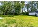 Spacious backyard with lush green lawn and mature trees at 6301 Prospect St, Indianapolis, IN 46203