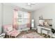 Bedroom featuring a pink chair, rug, vanity, and lots of natural light at 6301 Prospect St, Indianapolis, IN 46203