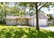 Charming single-story home with gray siding, a covered porch, and a well-manicured lawn at 6301 Prospect St, Indianapolis, IN 46203