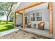Cozy front porch with seating, decorative pillows, and a natural wood beam overhead at 6301 Prospect St, Indianapolis, IN 46203