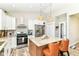 Stylish kitchen with white cabinetry, stainless steel appliances, and a granite-topped island at 6301 Prospect St, Indianapolis, IN 46203